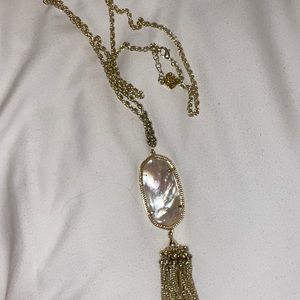 Kendra Scott long gold pendant necklace with tassels. Stone is ivory.